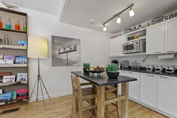 A kitchen with a table and chairs in the middle of it.